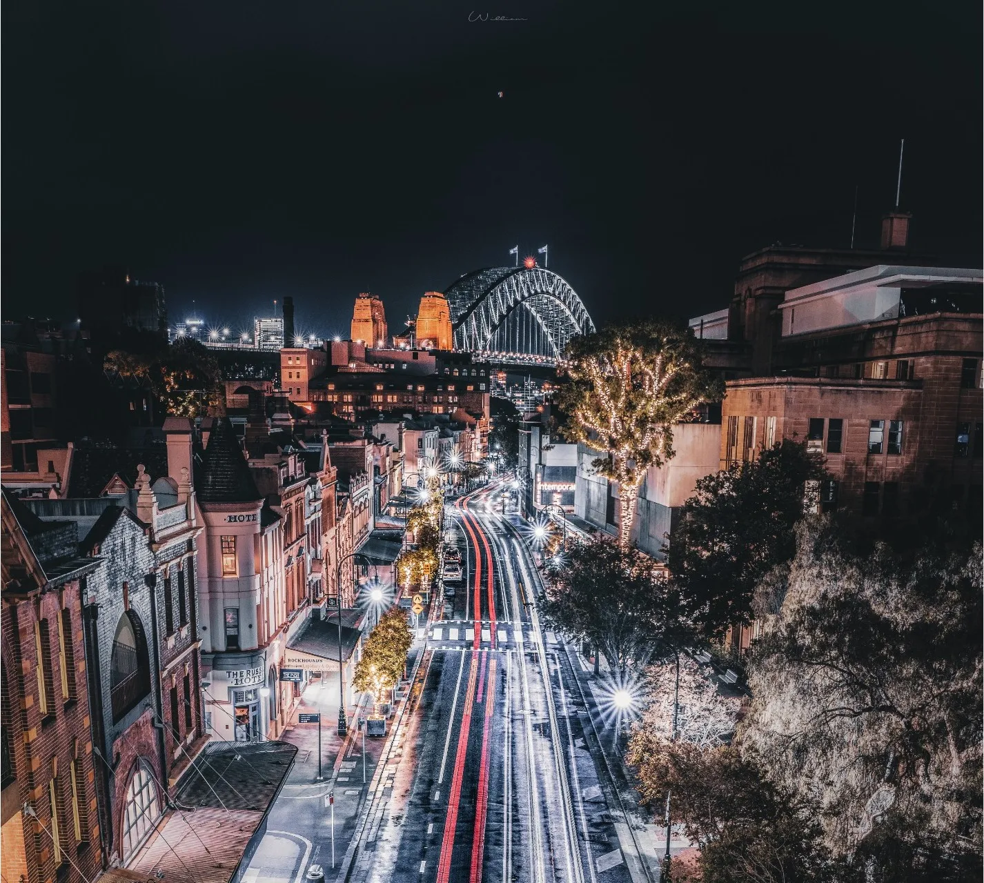 Sydney Harbour Bridge and city streets illuminated at night